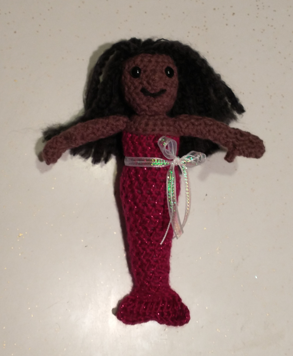 Mermiad with Ribbon A crocheted Black mermaid with a sparkly pink tail and a bow around her waist