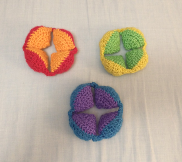 Puzzle Ball Segments Three colorful segments of a crocheted Amish puzzle ball