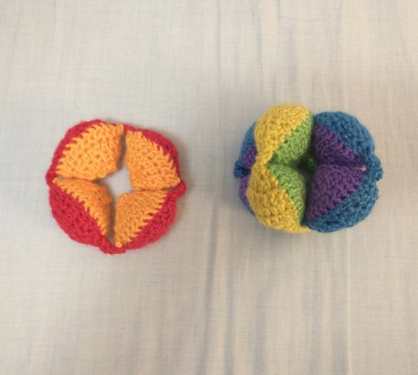 Puzzle Ball, Partially Assembled Three segments of a crocheted Amish puzzle ball, two of them stuck together